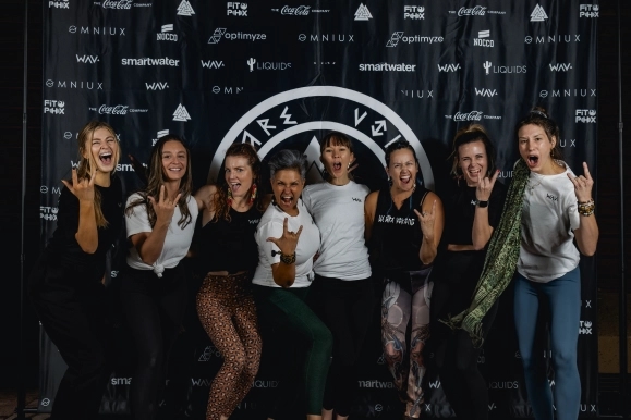 People standing in front of a step-and-repeat banner at We Are Viking Yoga