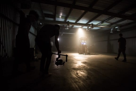 A camera crew filming on a set